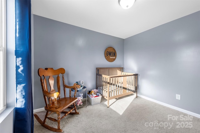 carpeted bedroom with a nursery area