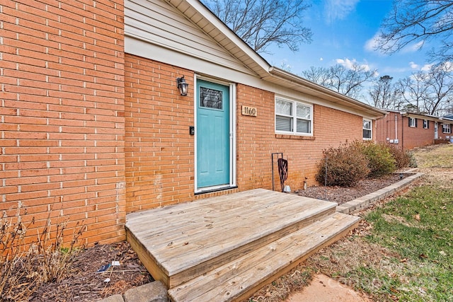 entrance to property featuring a wooden deck