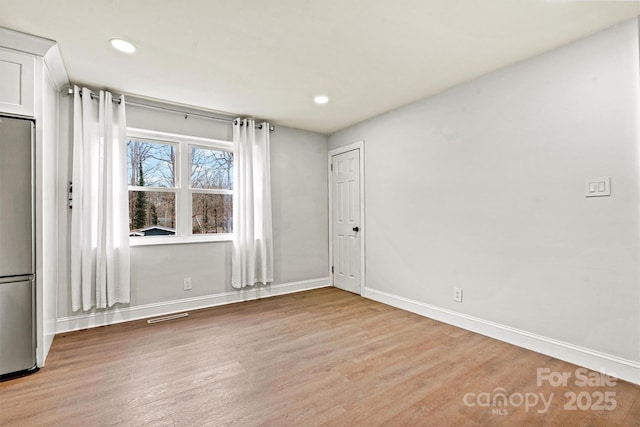 spare room with hardwood / wood-style flooring