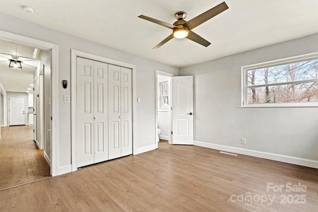 unfurnished bedroom with ceiling fan, light hardwood / wood-style floors, and a closet