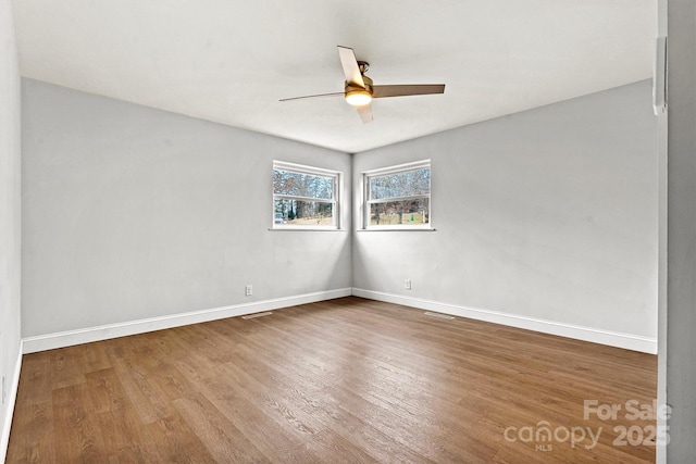 empty room featuring hardwood / wood-style flooring and ceiling fan