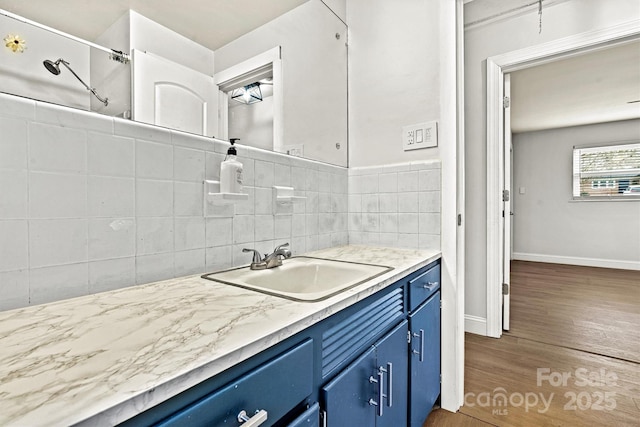 kitchen with sink, dark wood-type flooring, and blue cabinetry