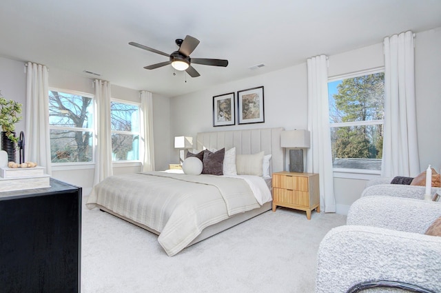 bedroom featuring ceiling fan, carpet flooring, and multiple windows