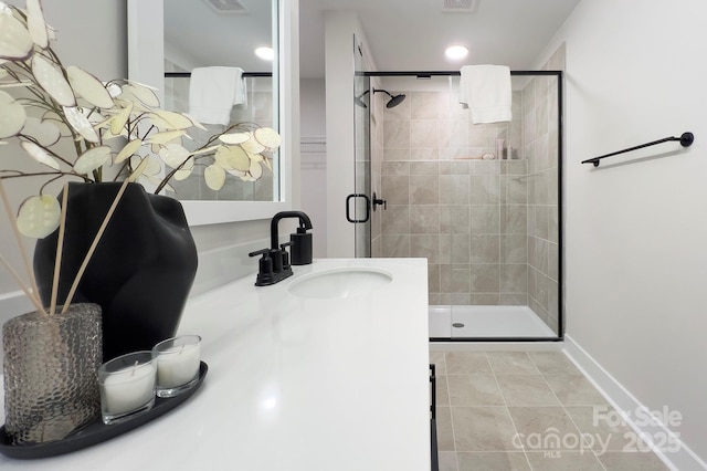 bathroom with vanity, an enclosed shower, and tile patterned floors