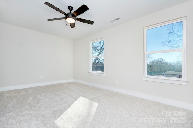 carpeted spare room featuring ceiling fan