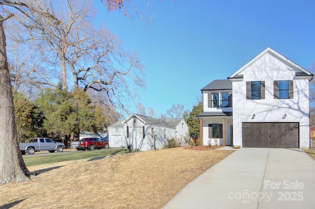 view of front of home with a garage and a front lawn