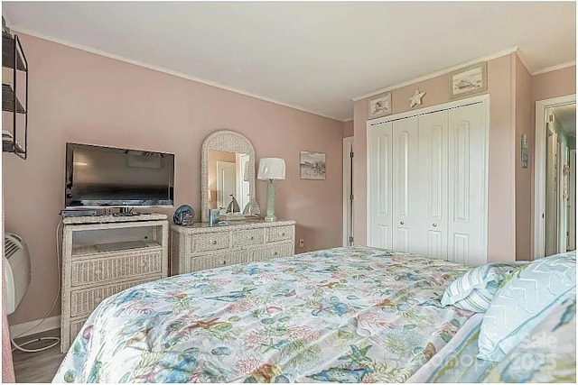 bedroom featuring a closet and crown molding