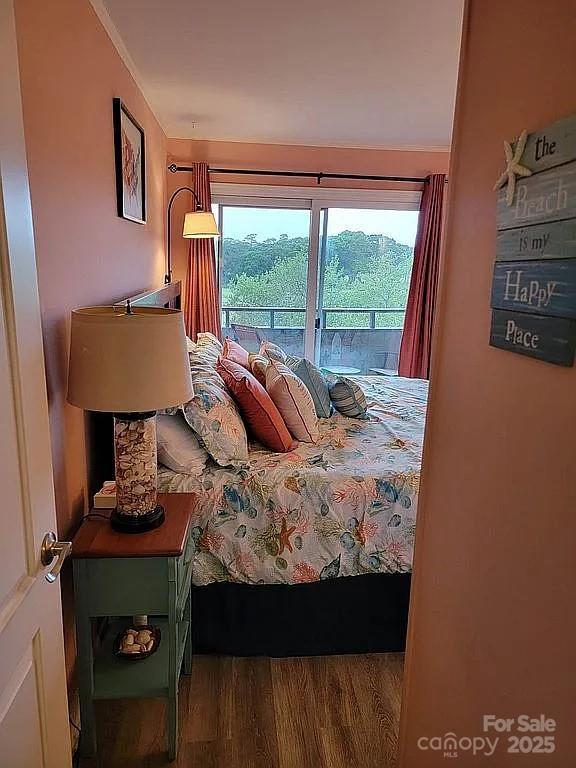 bedroom featuring hardwood / wood-style flooring and access to exterior