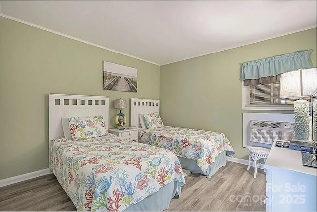 bedroom with radiator heating unit and hardwood / wood-style floors