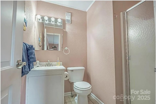 bathroom with toilet, tile patterned floors, a shower with door, vanity, and crown molding