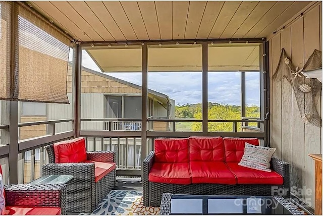 sunroom featuring wooden ceiling