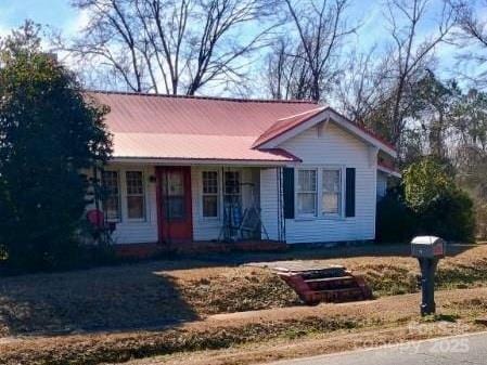 single story home featuring covered porch