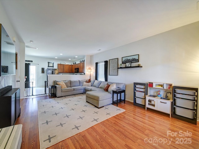 living room with light hardwood / wood-style flooring