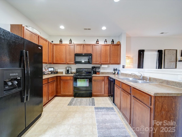 kitchen with sink, black appliances, and kitchen peninsula