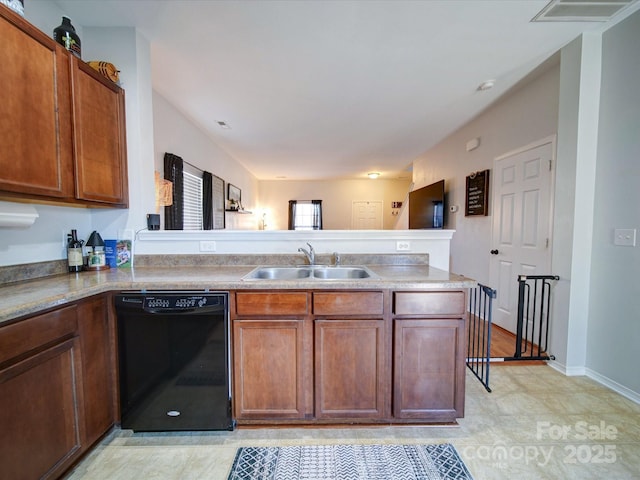 kitchen with sink, black dishwasher, and kitchen peninsula