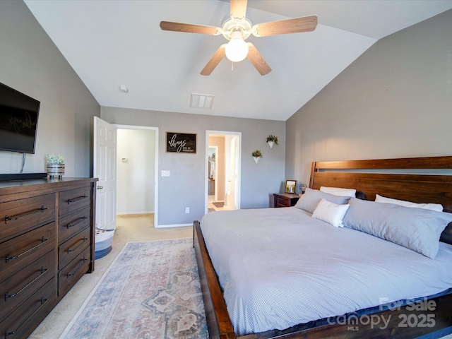 carpeted bedroom featuring lofted ceiling, ceiling fan, and connected bathroom