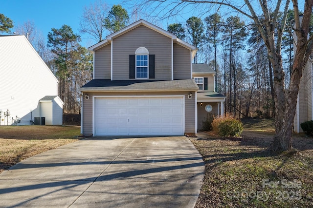 view of front property with a front lawn, central AC unit, and a garage