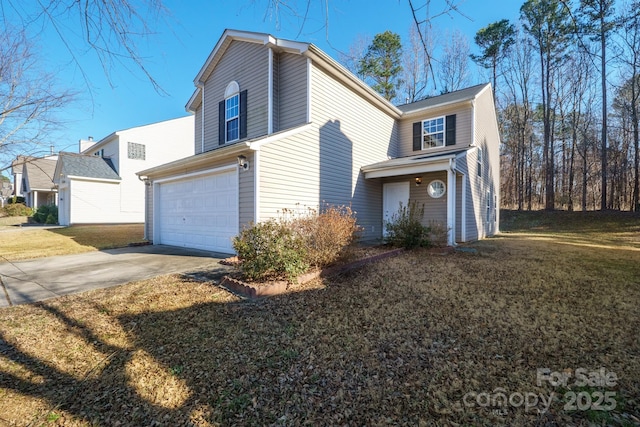 view of front of property featuring a front yard and a garage