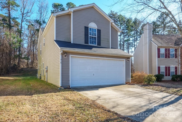 view of front facade with a front yard and a garage