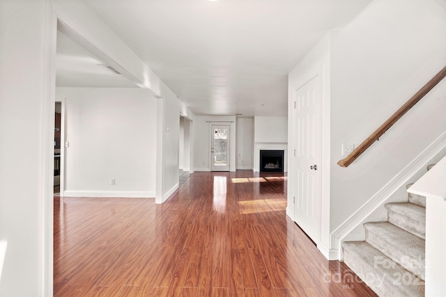 unfurnished living room featuring hardwood / wood-style flooring