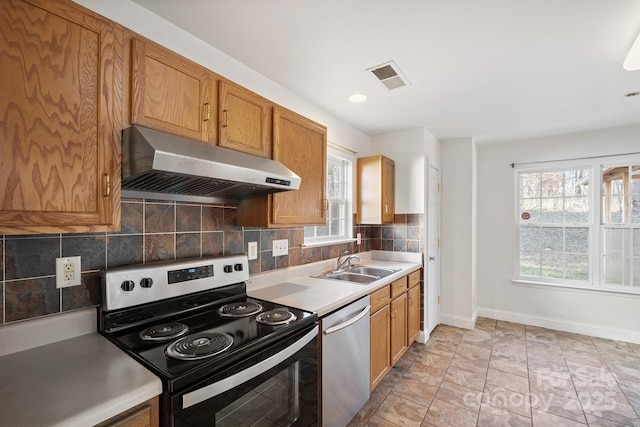 kitchen with sink, light tile patterned floors, backsplash, ventilation hood, and appliances with stainless steel finishes