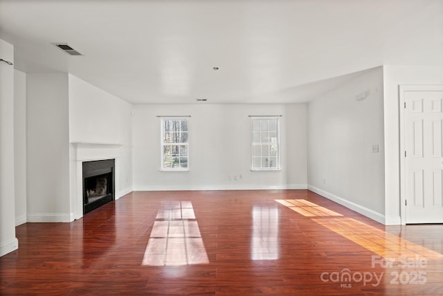 unfurnished living room featuring dark hardwood / wood-style floors