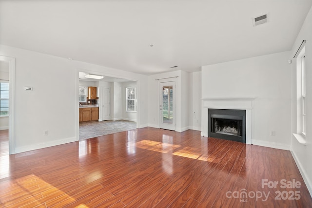 unfurnished living room with hardwood / wood-style floors