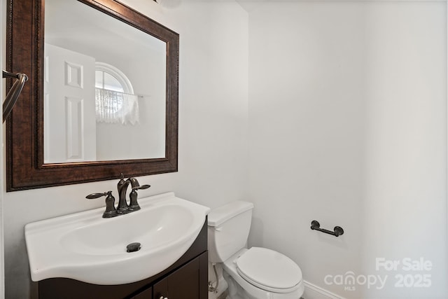 bathroom featuring toilet and vanity