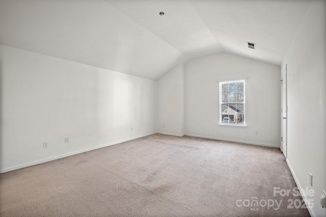 additional living space featuring light carpet and lofted ceiling