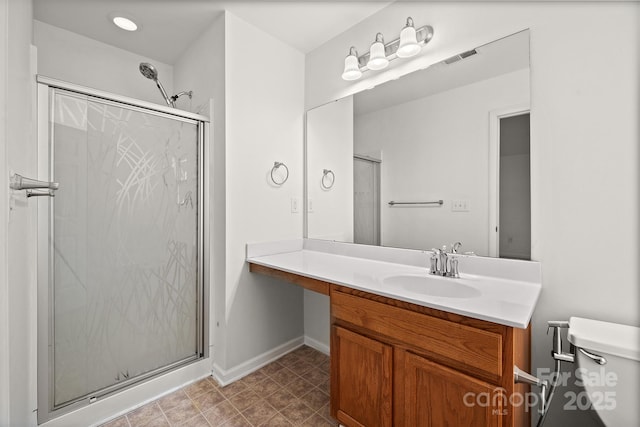 bathroom with walk in shower, vanity, and toilet