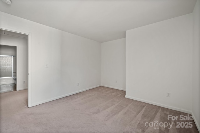 unfurnished room with light colored carpet