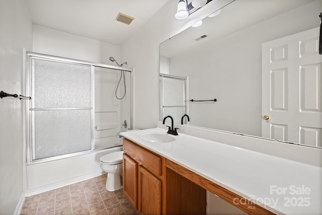 full bathroom with shower / bath combination with glass door, toilet, and vanity