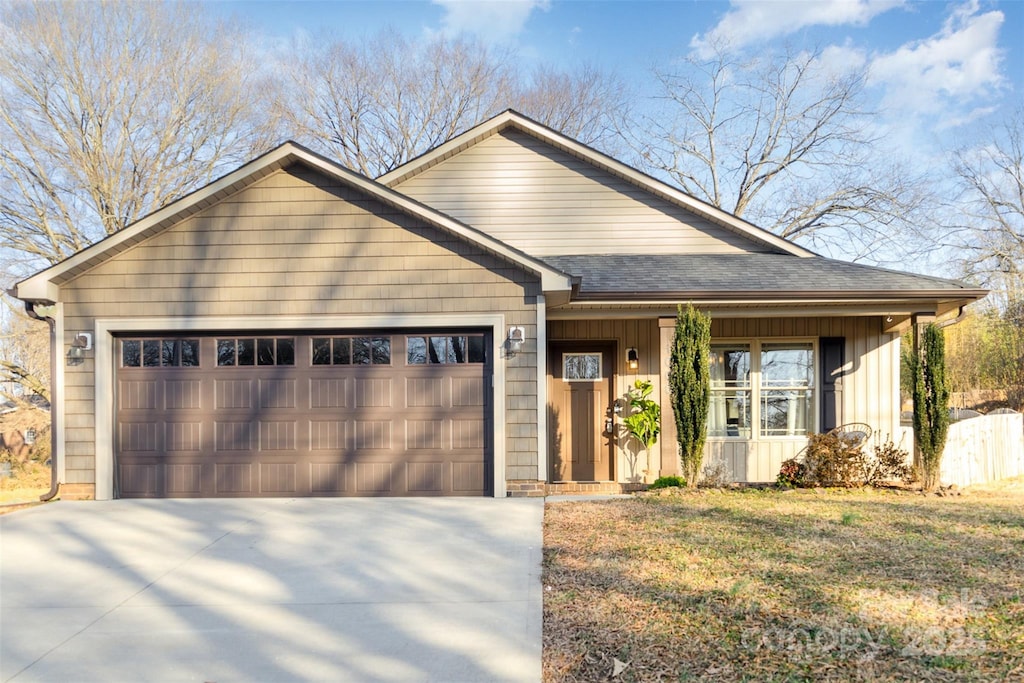 view of front of home with a front yard and a garage