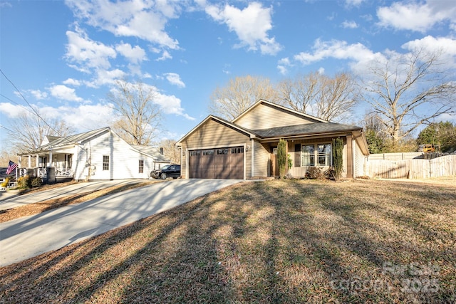 view of front of house featuring a porch, a front lawn, and a garage