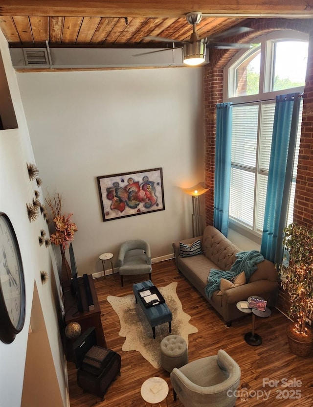 living room with wood ceiling, beamed ceiling, and wood-type flooring