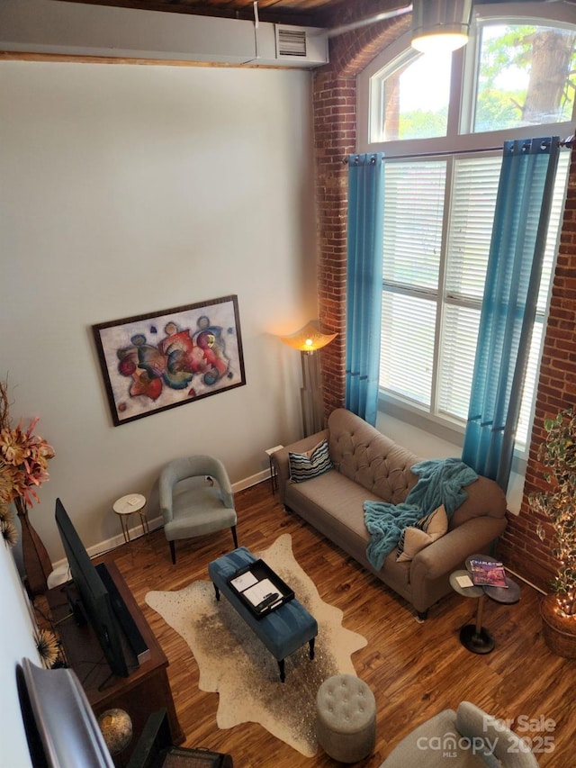 living room featuring a healthy amount of sunlight and hardwood / wood-style flooring