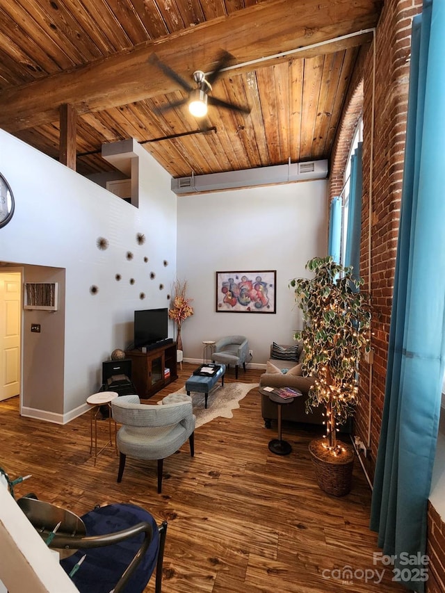 living room featuring beamed ceiling, hardwood / wood-style flooring, ceiling fan, and wood ceiling