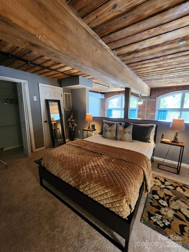 carpeted bedroom featuring wooden ceiling and beam ceiling