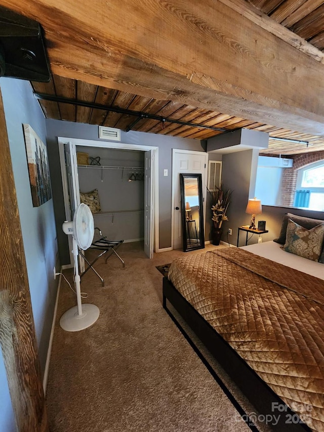 carpeted bedroom with two closets and wood ceiling