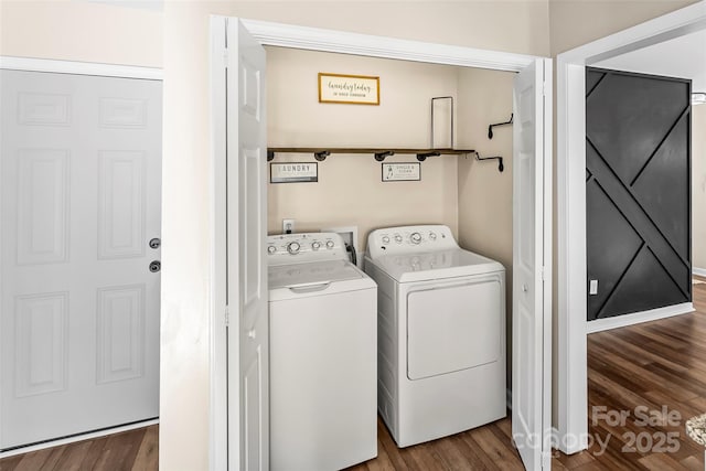 laundry area with washing machine and clothes dryer and wood-type flooring