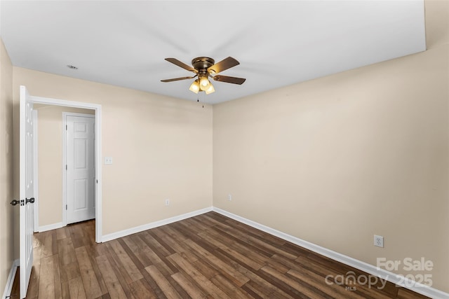 spare room featuring dark hardwood / wood-style floors and ceiling fan