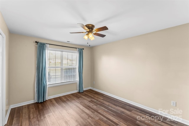 empty room with hardwood / wood-style floors and ceiling fan