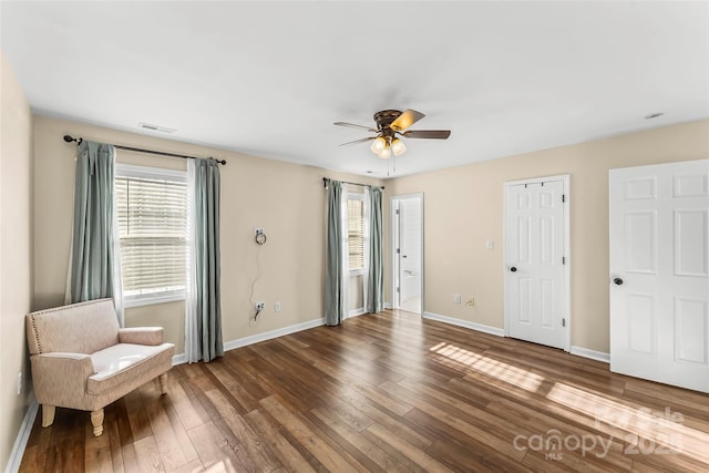 unfurnished room featuring ceiling fan and dark hardwood / wood-style flooring