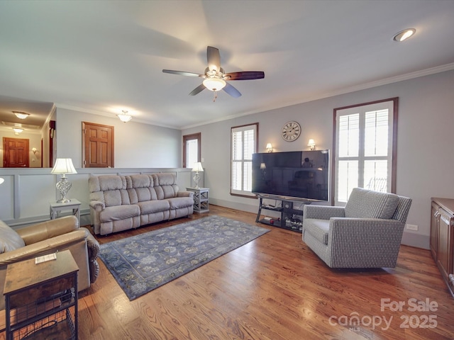 living room featuring a wealth of natural light, ornamental molding, and hardwood / wood-style floors