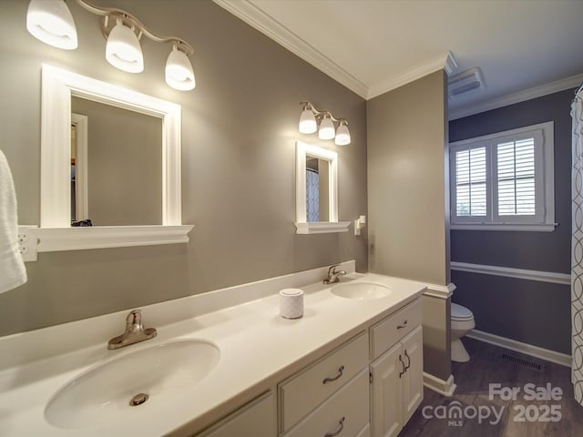 bathroom featuring ornamental molding, toilet, wood-type flooring, and vanity