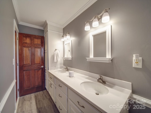 bathroom with vanity, crown molding, and wood-type flooring