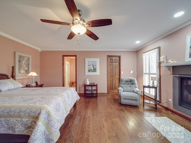 bedroom with hardwood / wood-style floors, ornamental molding, and ceiling fan