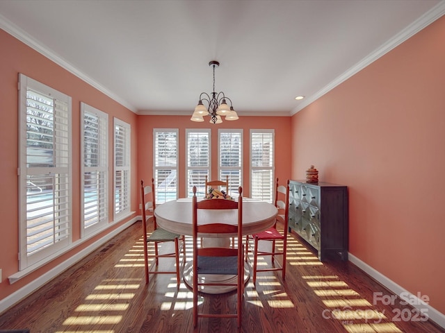 dining room with crown molding, dark hardwood / wood-style flooring, and a notable chandelier