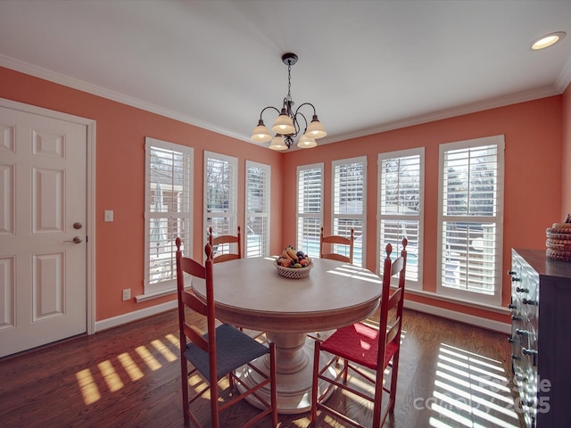 dining room with an inviting chandelier, dark hardwood / wood-style flooring, and ornamental molding