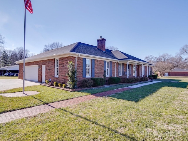 view of side of home with a yard and a garage